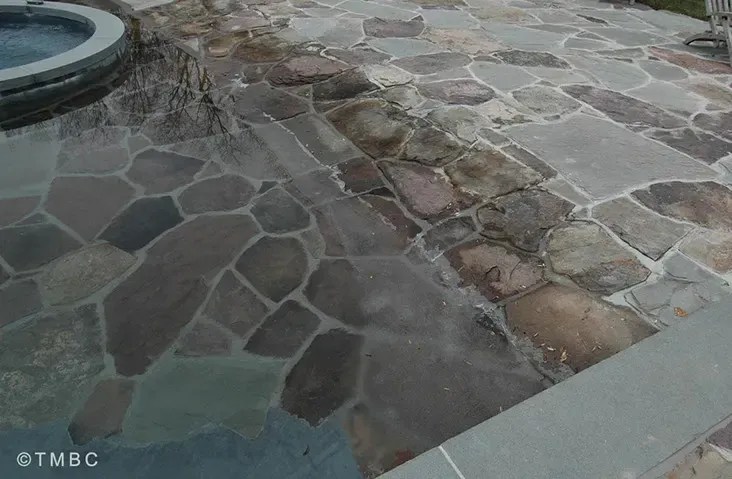Beach entry pool design with stonework, spa, and water feature details image 9