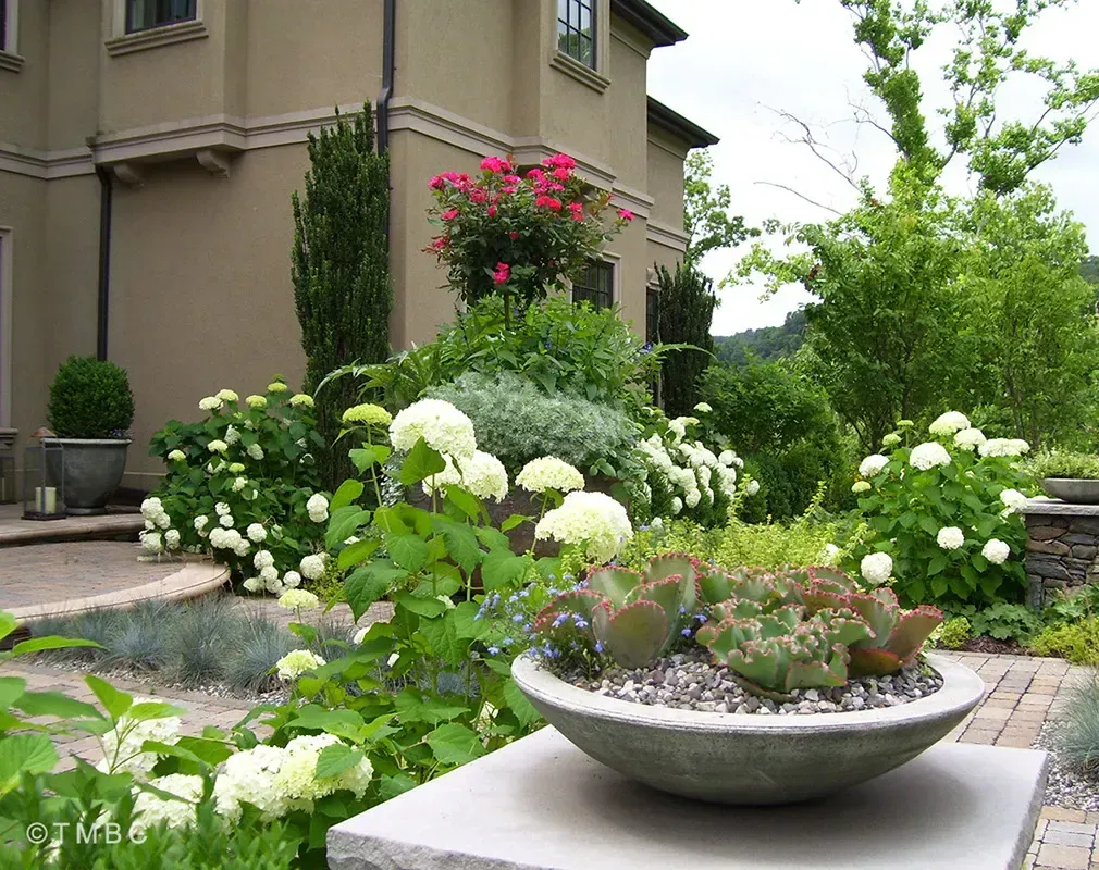 Nouveau Mediterranean landscape design with stonework, pottery, and courtyard planting image 6